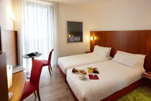 Un pat sau paturi într-o cameră la Vicenza Tiepolo Hotel
