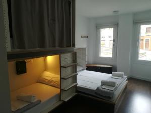 A bed or beds in a room at Agora Hostel