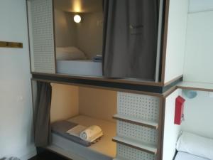 A bed or beds in a room at Agora Hostel