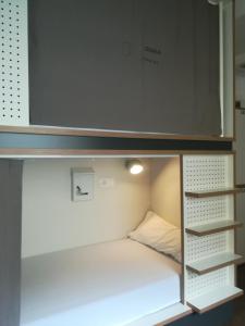 A bed or beds in a room at Agora Hostel