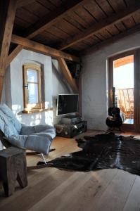 a living room with a couch and a television at Normandia in Kuźnica