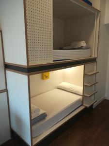 A bed or beds in a room at Agora Hostel