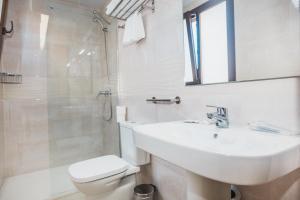 a bathroom with a sink and a toilet and a shower at Solesperit in Lloret de Mar