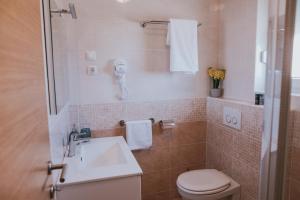 a small bathroom with a toilet and a sink at Poolside Hideout Apartments in Novalja