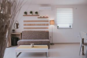 a living room with a couch and a table at Poolside Hideout Apartments in Novalja