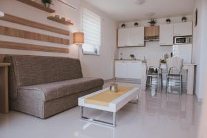 a living room with a couch and a table at Poolside Hideout Apartments in Novalja