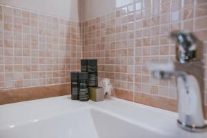 a bathroom with a sink with two bottles on it at Poolside Hideout Apartments in Novalja