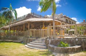 a resort with a staircase leading up to a building at Sunset Reef Resort & Spa in Pointe aux Piments