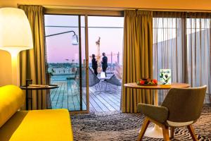 a hotel room with a view of a balcony at Radisson Blu Hotel Bordeaux in Bordeaux