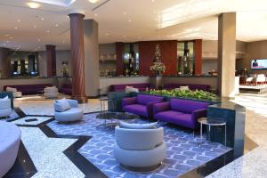 a hotel lobby with purple couches and tables at Grand Cevahir Hotel Convention Center in Istanbul