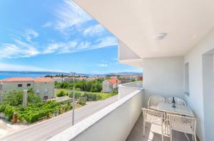 a balcony with a table and chairs and a view at Radic apartments in Kaštela