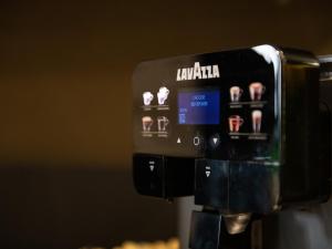 a coffee machine with the words laukaia on it at Martini Castello Boutique Rooms - Historic Center & Cathedral in Cagliari