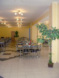 a dining room with tables and chairs and a unintention at Hotel Kapitan Morey in Anapa