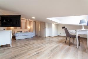 a living room with a desk and a bed at Palazzo Lombardi Al Vicolo in Sassari