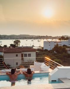 two people in a swimming pool watching the sunset at CASA DI NONNA ANNY in Porto Heli
