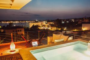 a balcony with a swimming pool on top of a building at CASA DI NONNA ANNY in Porto Heli