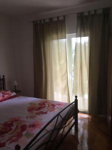 a bedroom with a bed and a window with curtains at House Kupina in Gdinj +27 photos