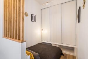 a bedroom with a bed and a cabinet at HONORÊ - Suite Baleine in Lyon