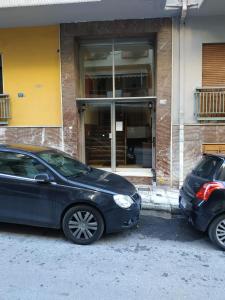 two cars parked in front of a building at TONI'S Cute 2BD Apartment in Koukaki! in Athens