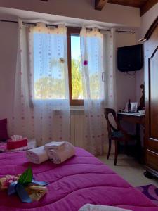 a bedroom with two beds and a desk and a window at Da Francesca in Scilla