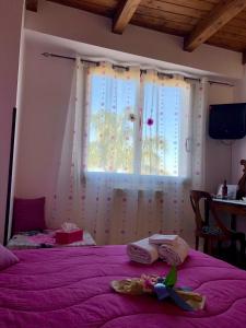 a bedroom with a purple bed with a window at Da Francesca in Scilla