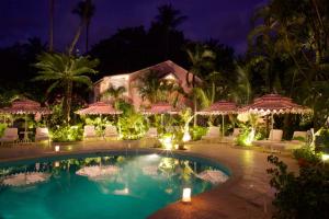 a resort with a swimming pool at night at Cobblers Cove - Barbados in Saint Peter