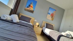 een slaapkamer met 2 bedden en een vuurtoren aan de muur bij Salou Med Apartamentos in Salou +29 foto's