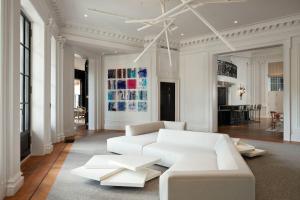 a living room with a white couch and a table at Placemakr Dupont Circle in Washington, D.C.