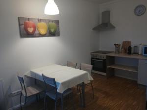 a kitchen with a table and chairs and a kitchen with a stove at Zur Sternschnuppe in Borken