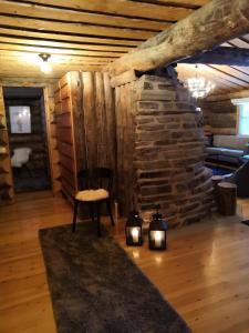 a living room with a chair and a stone wall at Ruka Aava in Ruka