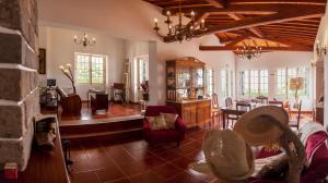 a living room with a couch and a dining room at Quinta das Bolas in Ponta Delgada