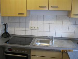 a kitchen with a sink and a counter top at Ferienwohnung Anna in Maroldsweisach +24 photos