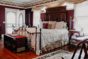 a bedroom with a large bed with a canopy at Aurora Staples Inn in Stillwater