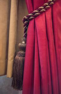 a close up of a red curtain with a broom at The Montana Hotel in London