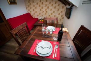 a wooden table with plates and wine glasses on it at Villa Mia in Dubrovnik