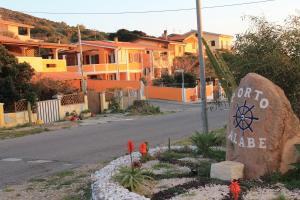 a sign for a village on a street with houses at La Casa Di Angelo in Tresnuraghes