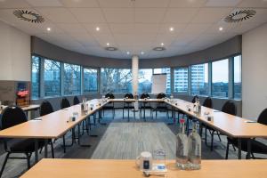 a conference room with tables and chairs and windows at Egon Hotel Hamburg City in Hamburg +21 photos