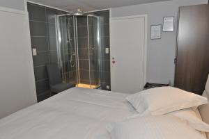 Ένα ή περισσότερα κρεβάτια σε δωμάτιο στο Hotel Palace