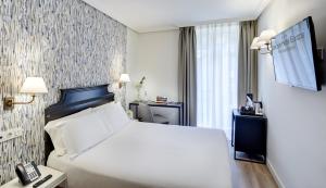 Cama o camas de una habitación en Sercotel Hotel Europa