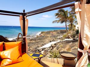 a room with a view of the beach at Vacation Apartment Lanzarote VAL in Puerto del Carmen