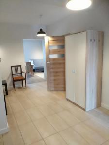 a room with a door and a table and a chair at Apartamenty Willa Nawigator in Gdynia