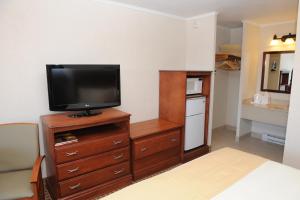 um quarto com uma televisão em cima de uma cómoda em Oceanus Motel - Rehoboth Beach em Rehoboth Beach