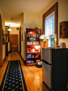 a kitchen with a refrigerator and a book shelf at Lamberson Guest House in Galena