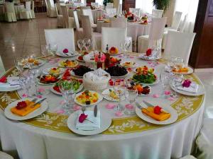a white table with plates of food on it at Hotel Kanione in Çerenisht