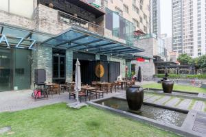 a patio with tables and chairs and a fountain at Five Studio - Empire Damansara in Petaling Jaya