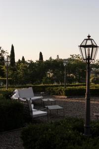 a street light and chairs and a lamp post at Hotel La Collegiata - Adults Only in San Gimignano