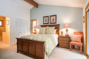 a bedroom with a bed and a chair at Sage Road 415A in Ketchum
