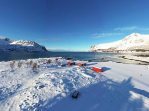 an aerial view of a village in the snow at Rystad Lofoten Camping in Rystad +3 photos