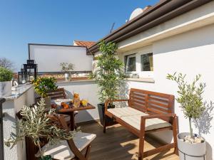 a patio with two chairs and a table on a balcony at Dream Istria Holiday in Poreč