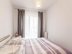Łóżko lub łóżka w pokoju w obiekcie Apartament Rybacka 12A/68, Kołobrzeg